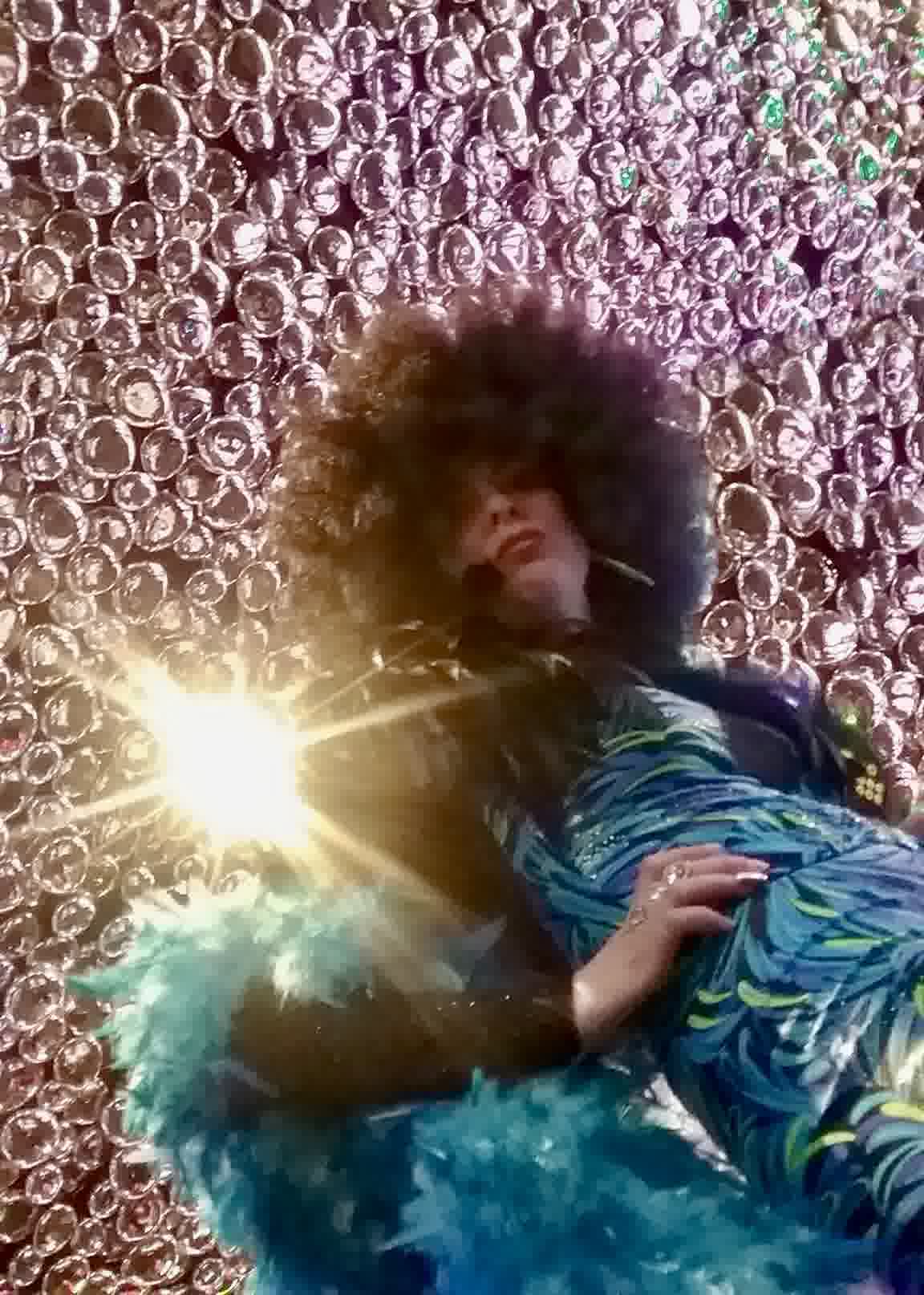 Aurora as Shirley Bassey in feathers and sparkle